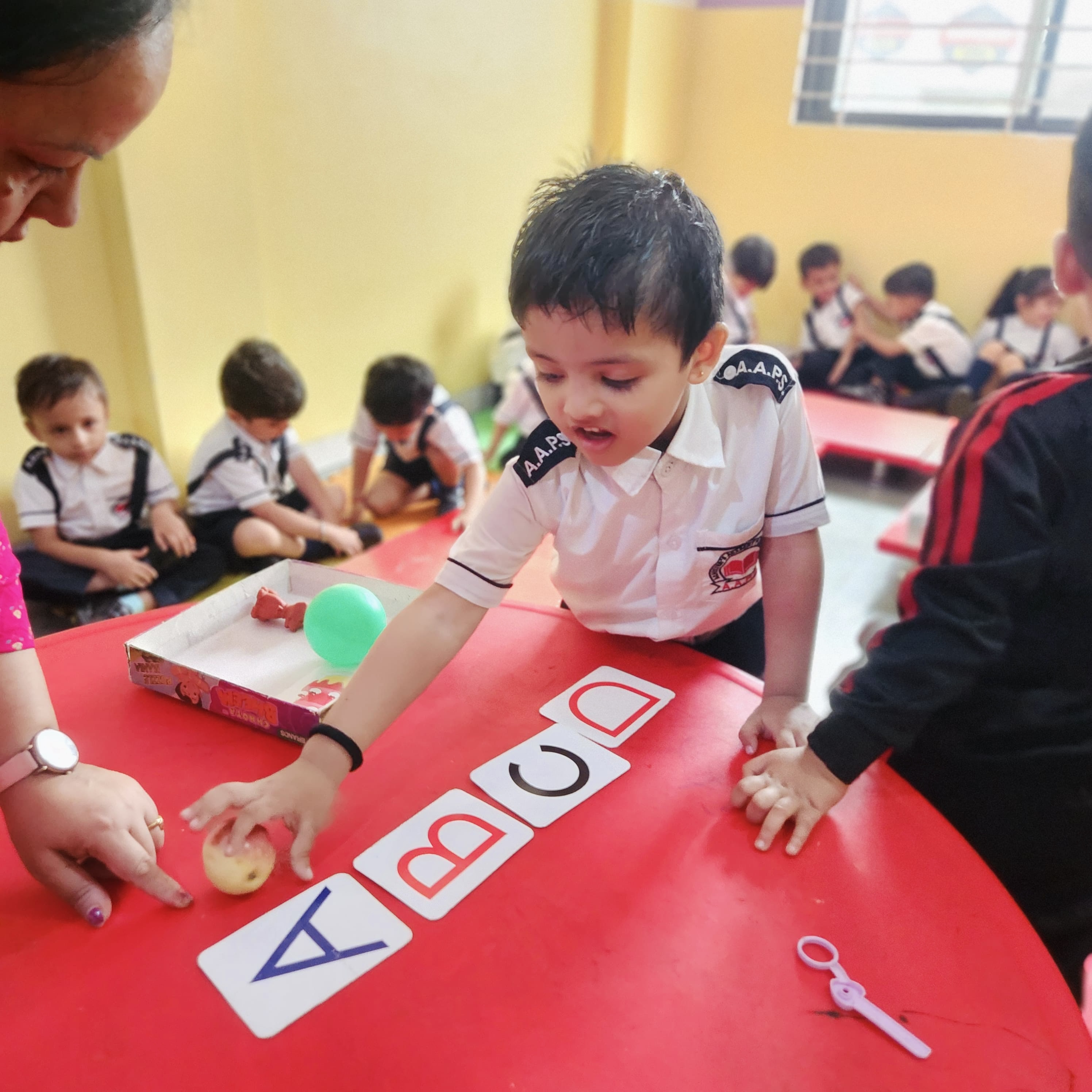 Phonics Object Matching - Child associating letters with real objects